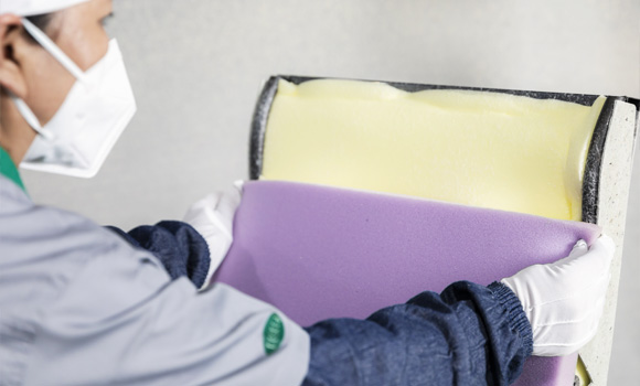 A worker is sticking cotton to a sofa