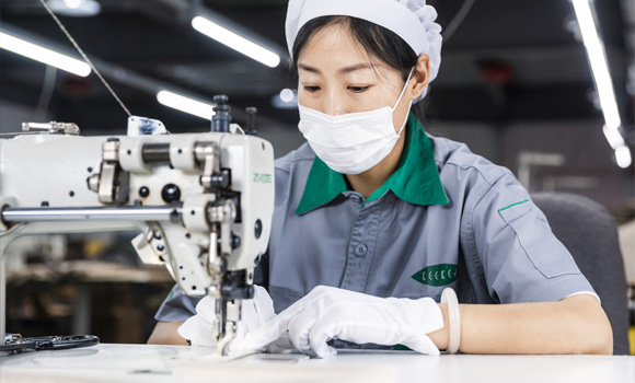 A female worker is sewing
