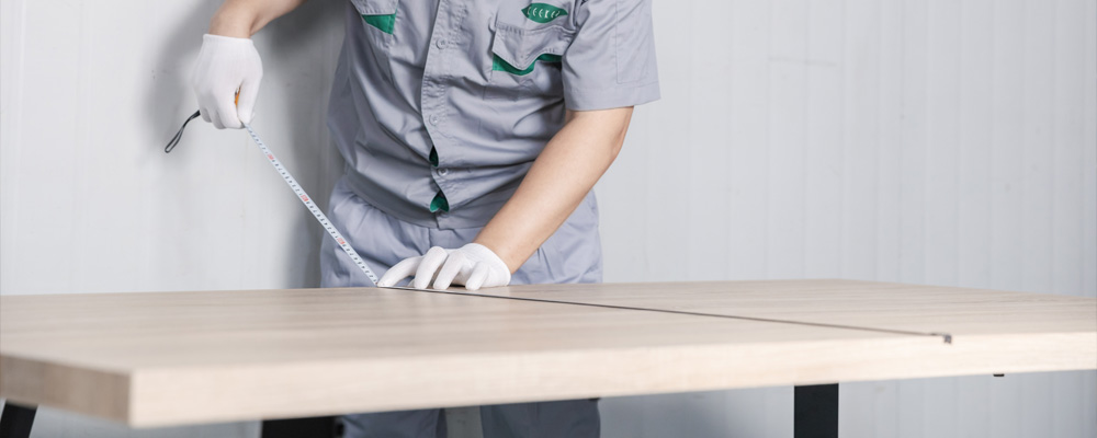 A worker is touching the table