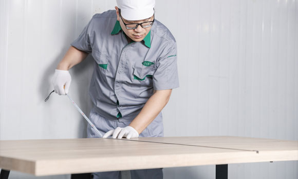 Male worker is measuring the board