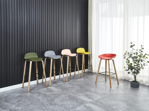 A set of bar stools against the wall