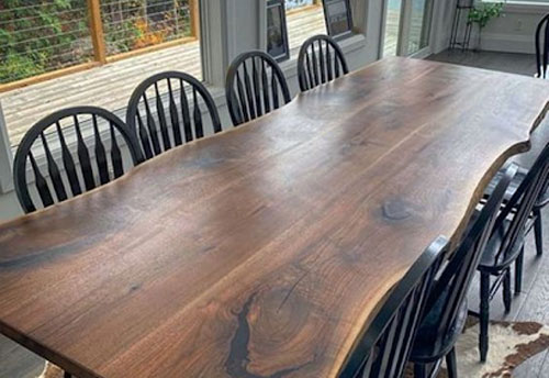 Table Made From wood with upholstered Chairs