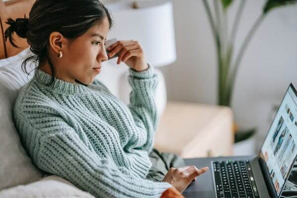 Focused young ethnic woman with a laptop